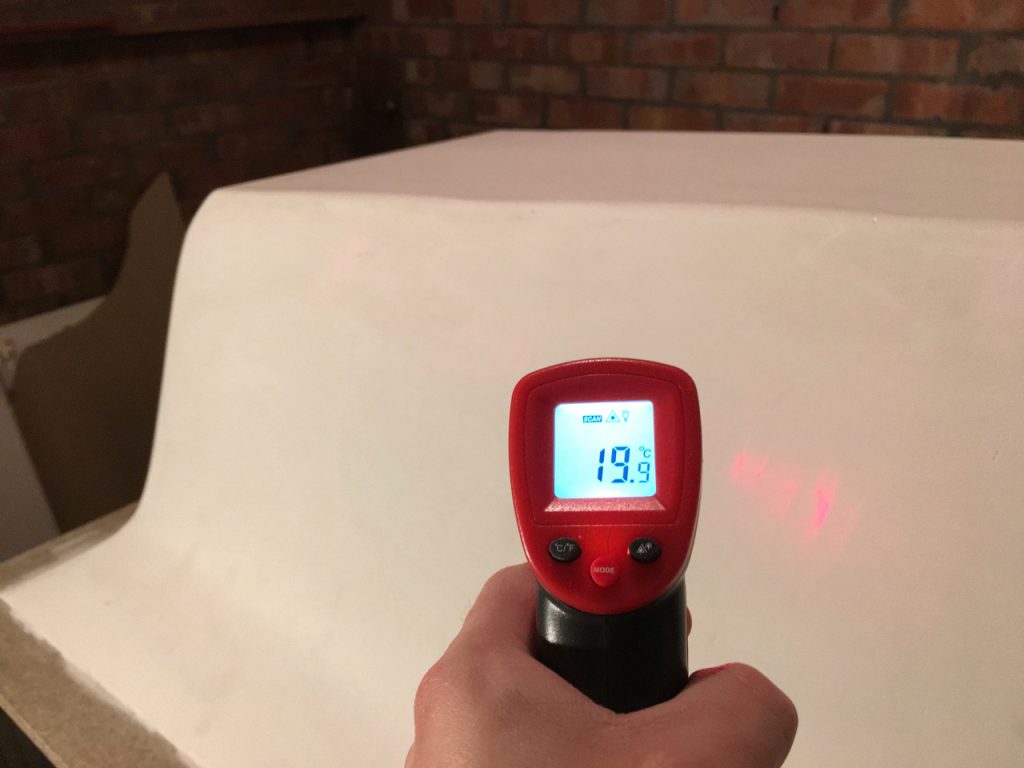 Checking surface temperature with an infrared thermometer.